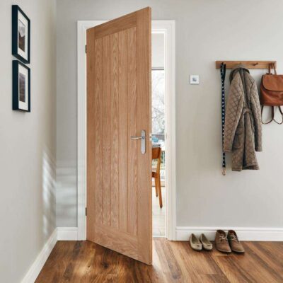 Holdenby Oak internal door shown open in a modern hallway interior