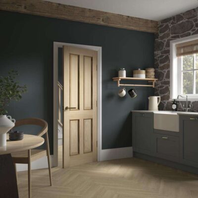 Howdens Rockingham Oak four-panel door fitted in a dark kitchen
