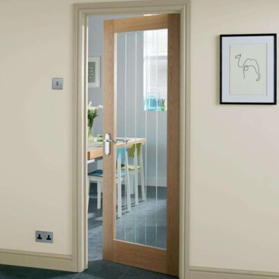 Howdens Genoa Oak clear glazed internal door fitted in a home