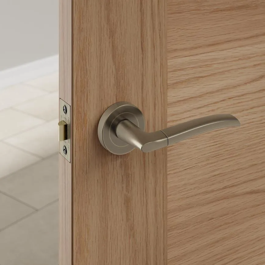 Newington Antique Brass Lever Handle Installed on Wooden Door Newington antique brass lever on rose handle fitted to an oak internal door