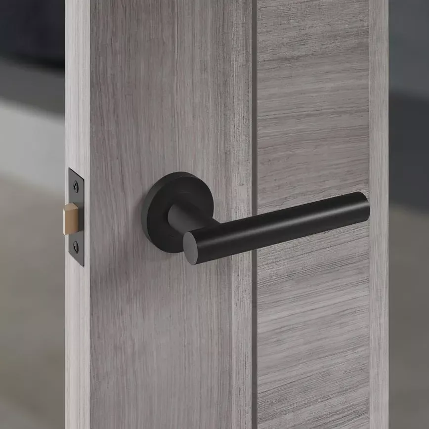 Cesano matt black lever on rose handle fitted to a grey wood-effect internal door