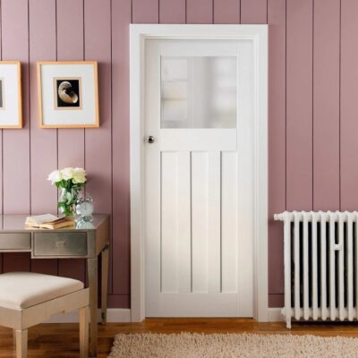 White primed 1930s DX internal door with obscure glass fitted in a home